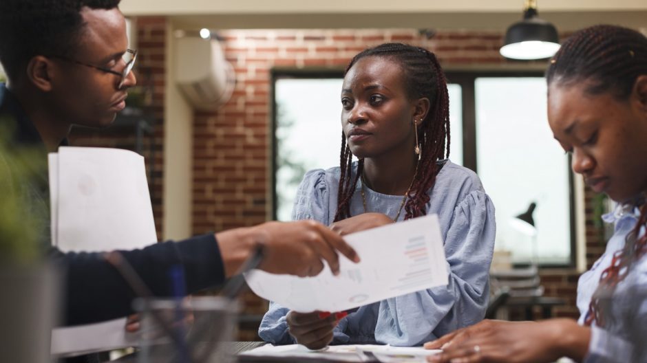 Marketing company team leader briefing coworkers about startup project presentation. Financial advisor informing employees about business strategy and development progress in meetings room.